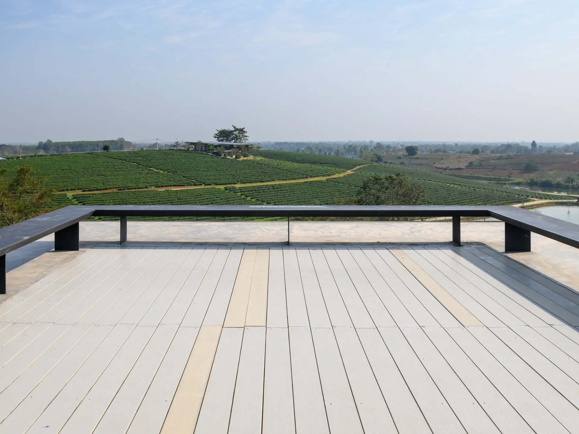 Sk Bench on wooden patio of roof with tea plantation