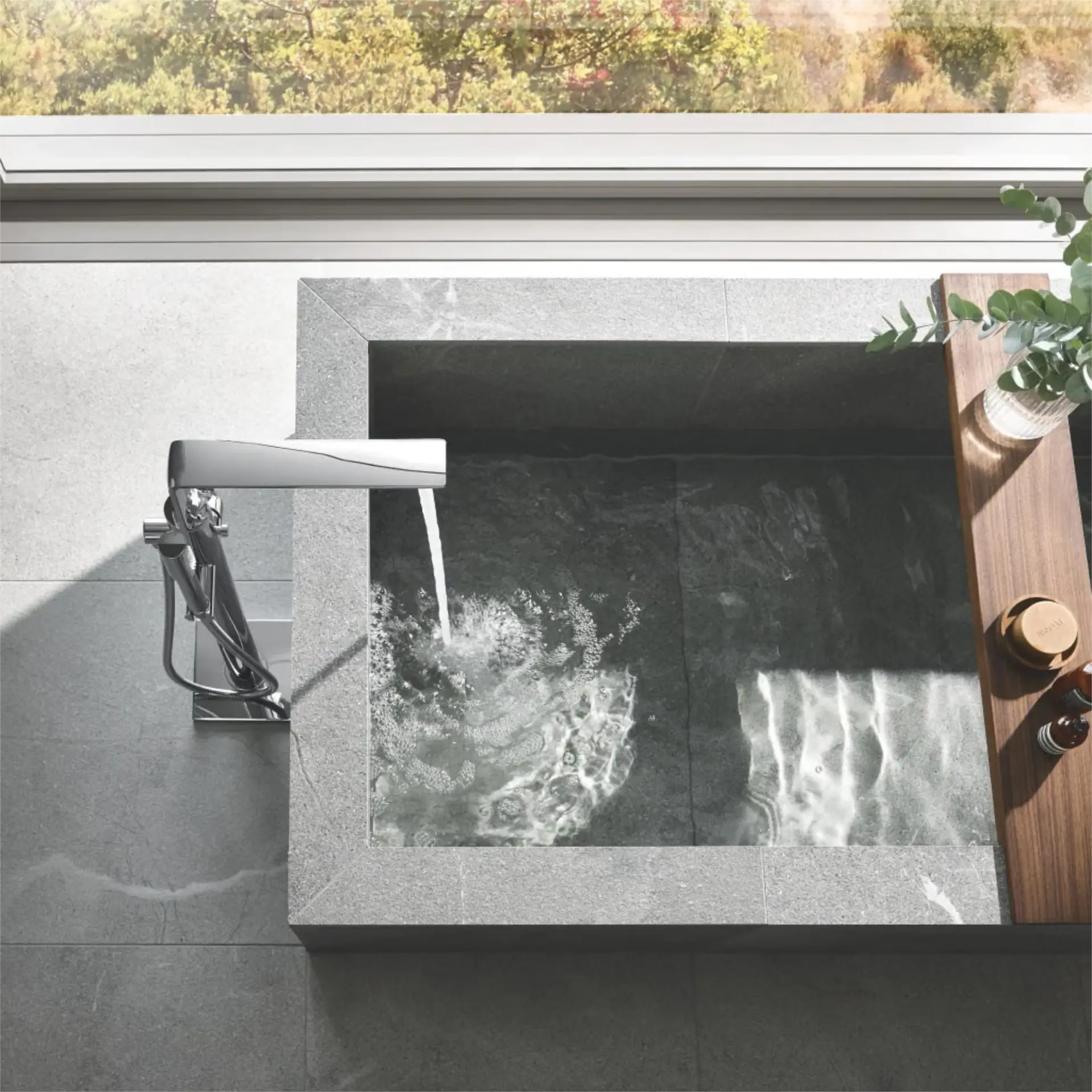 Sk grohe Stone soaking tub with chrome faucet.