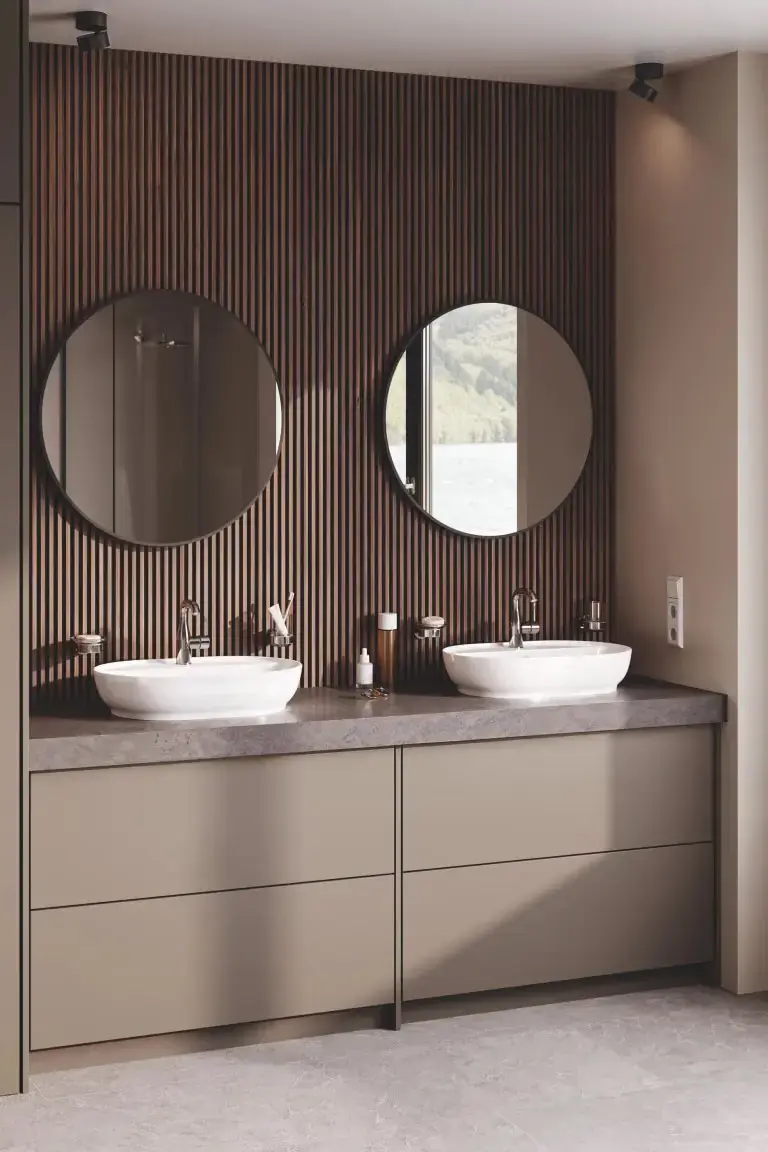 Sk grohe Double vanity with round mirrors and wood slat wall.